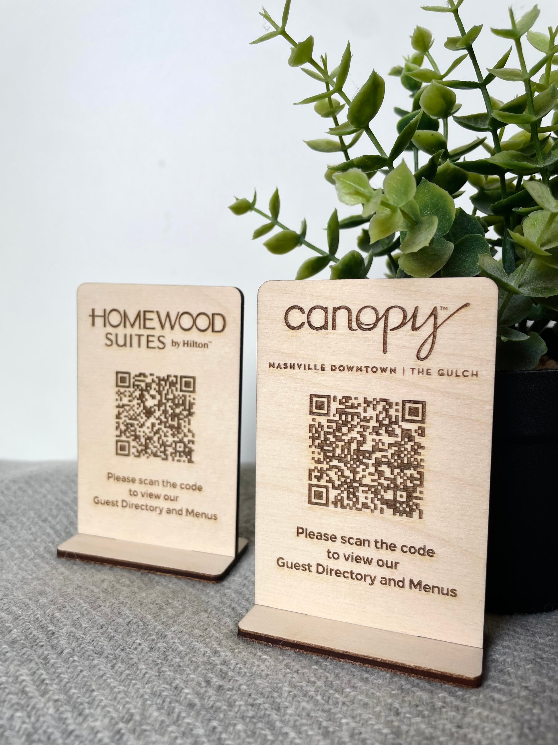 Plaques QR Code personnalisées en bois avec support de table pour hôtels, permettant d'accéder au menu numérique, aux informations et aux services.